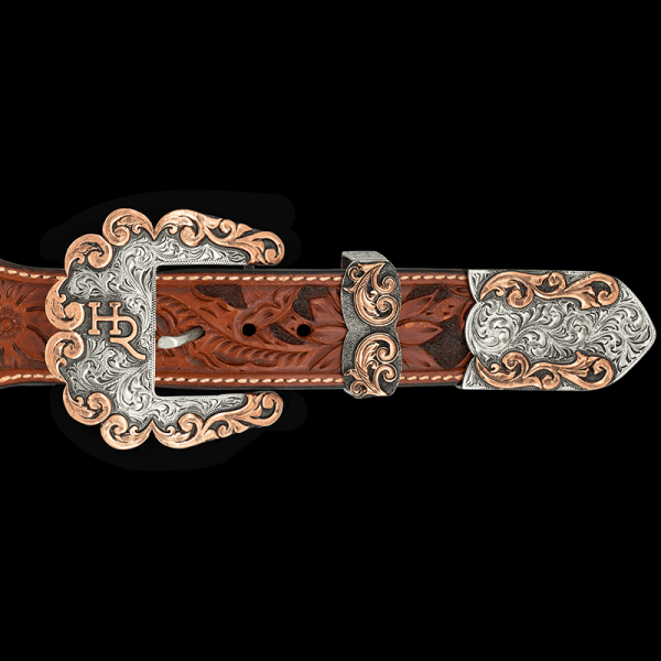Show off your unique Western Style with the San Angelo Custom Three Piece Buckle Set! Customize with your Ranch brand or initials. Featuring hand engraving and copper scrollwork. Order now!